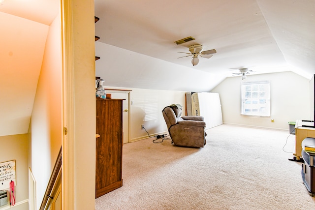 sitting room with vaulted ceiling, ceiling fan, and carpet floors