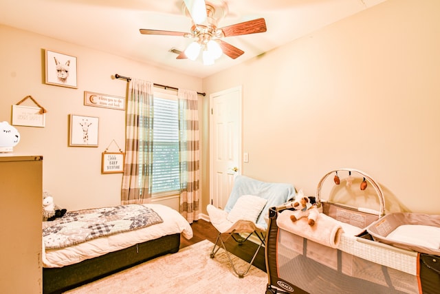 bedroom with ceiling fan and hardwood / wood-style flooring