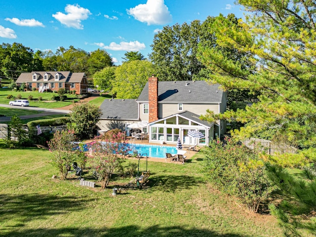 rear view of property with a lawn