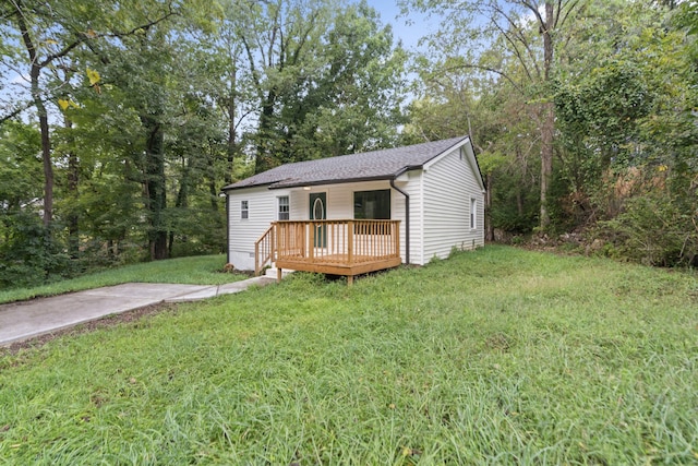 view of front of home featuring a front yard and a deck