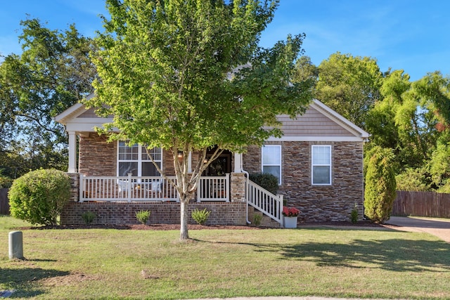 obstructed view of property featuring a porch and a front lawn