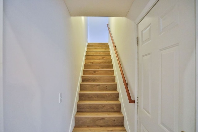 staircase with hardwood / wood-style floors