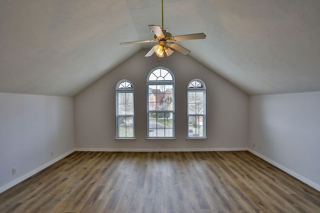 additional living space with lofted ceiling, ceiling fan, and dark hardwood / wood-style floors