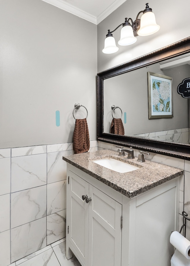 bathroom featuring crown molding, vanity, and tile walls