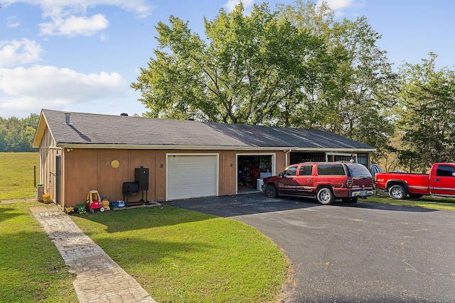 ranch-style house featuring a garage and a front yard