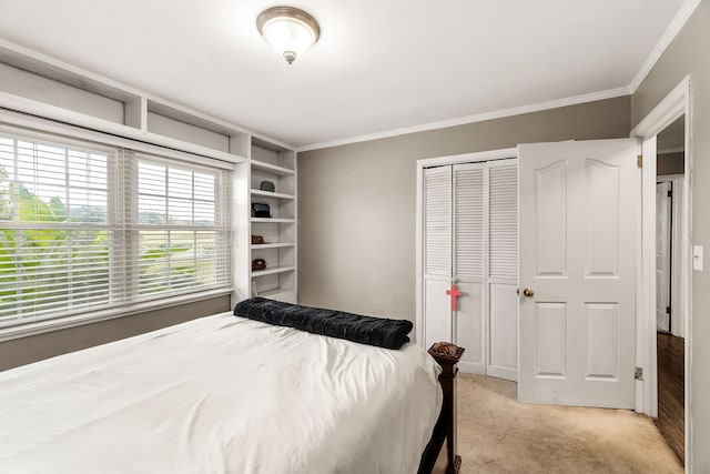 bedroom with crown molding, light colored carpet, and a closet