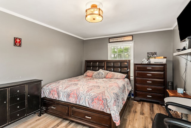 bedroom with crown molding and light wood-type flooring