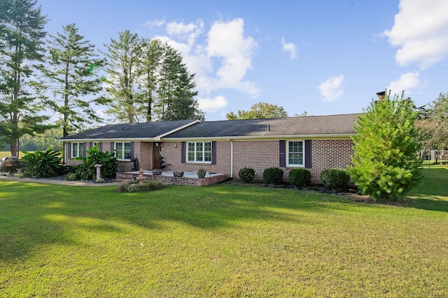 ranch-style home with a front lawn and a patio