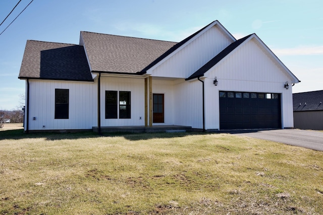 modern farmhouse style home with a garage and a front lawn