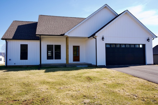 modern inspired farmhouse featuring a garage and a front yard