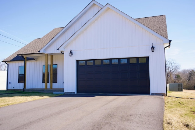 modern farmhouse featuring a garage and a front yard