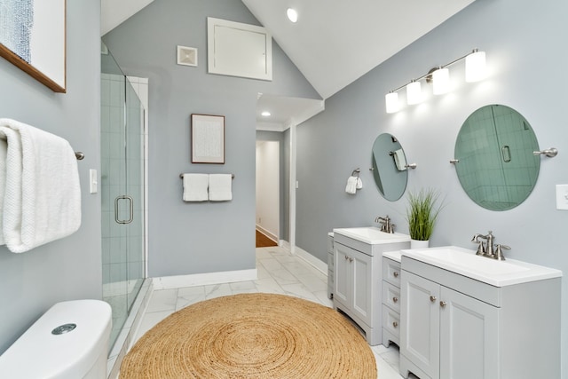 bathroom with vanity, a shower with shower door, and lofted ceiling