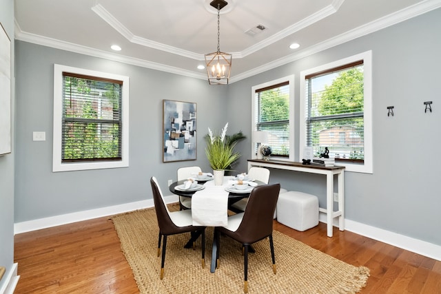 dining area featuring crown molding, light hardwood / wood-style flooring, and a healthy amount of sunlight