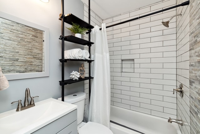 full bathroom featuring shower / bath combo, vanity, and toilet