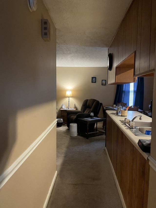 office area with a textured ceiling and sink