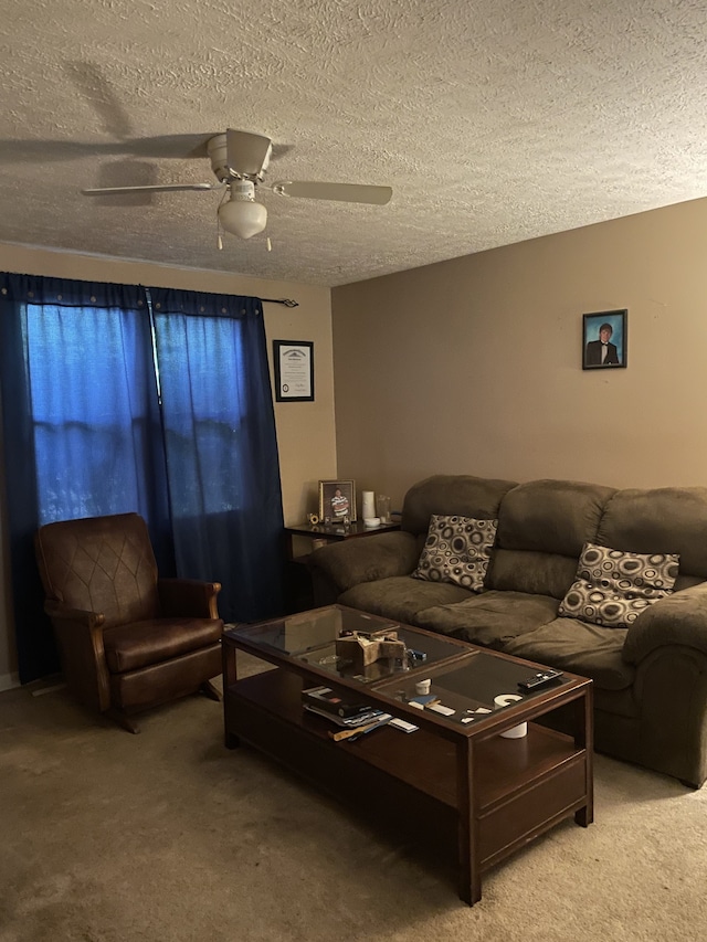 carpeted living room featuring a textured ceiling and ceiling fan