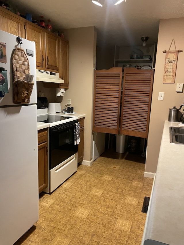 kitchen with ventilation hood, white appliances, and sink