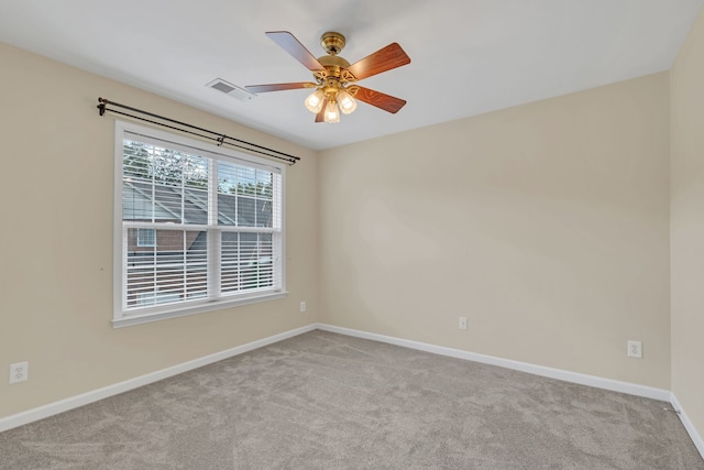 carpeted spare room featuring ceiling fan