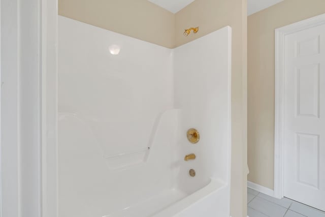 bathroom featuring  shower combination and tile patterned floors