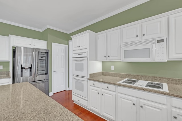 kitchen featuring white appliances, dark wood-type flooring, ornamental molding, white cabinetry, and light stone counters