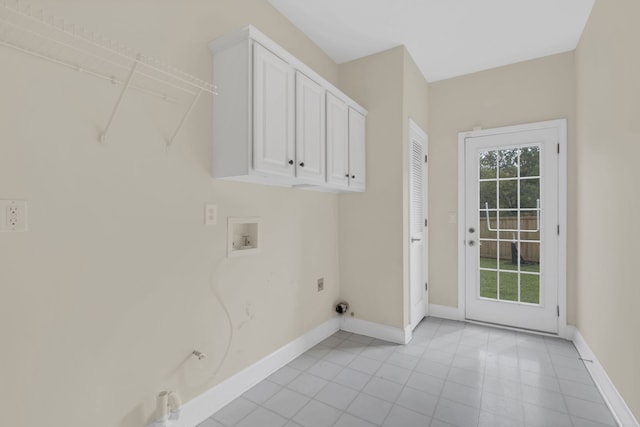 washroom featuring washer hookup, cabinets, light tile patterned floors, and electric dryer hookup