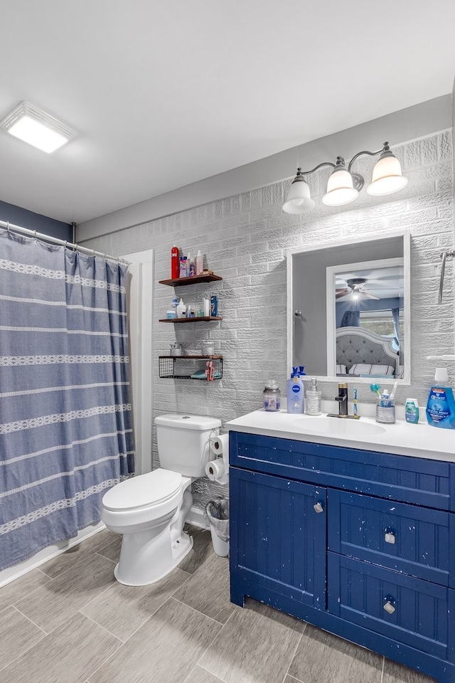 bathroom featuring vanity, toilet, and a shower with curtain