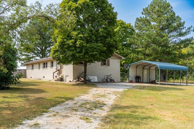 back of house with a yard and a carport