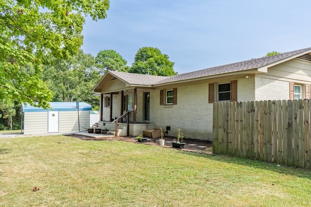 view of front facade with a front lawn and a shed