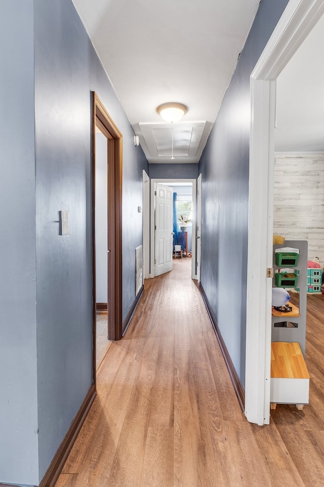 corridor with light hardwood / wood-style floors