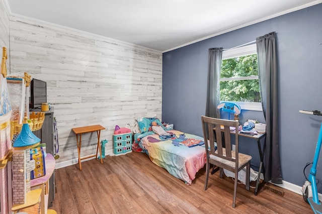 bedroom with hardwood / wood-style floors and crown molding