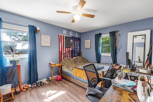 bedroom with ceiling fan and hardwood / wood-style flooring