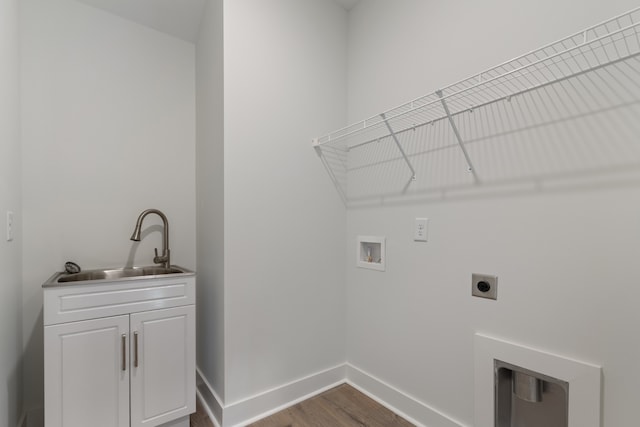 washroom with washer hookup, sink, cabinets, hardwood / wood-style floors, and electric dryer hookup