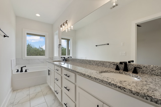 bathroom with a bathing tub and vanity