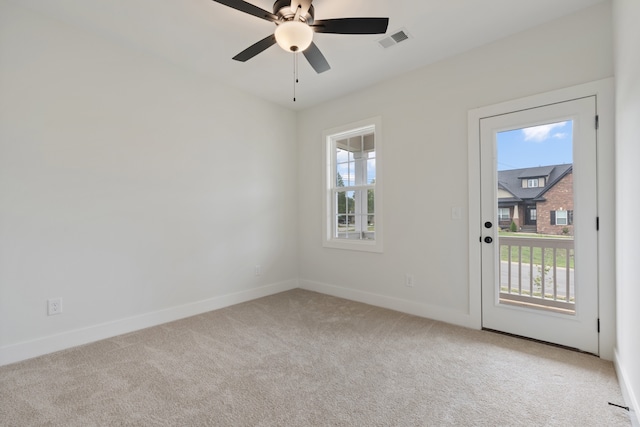 carpeted empty room featuring ceiling fan