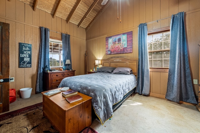 carpeted bedroom with vaulted ceiling with beams, wood ceiling, wood walls, and ceiling fan