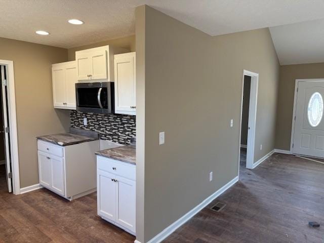 kitchen with backsplash, white cabinets, and dark hardwood / wood-style floors