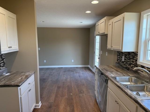 kitchen with white cabinets, stainless steel dishwasher, and sink