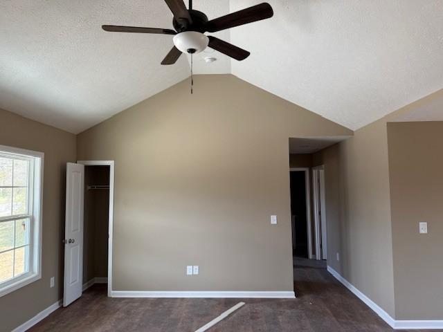 spare room featuring vaulted ceiling and ceiling fan