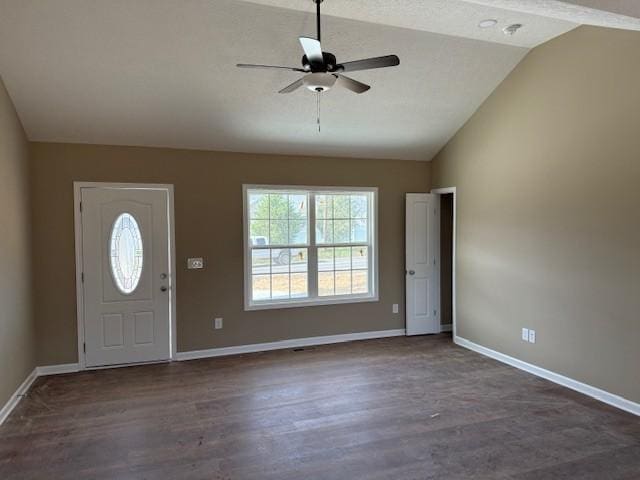 foyer entrance featuring ceiling fan, dark hardwood / wood-style floors, and vaulted ceiling