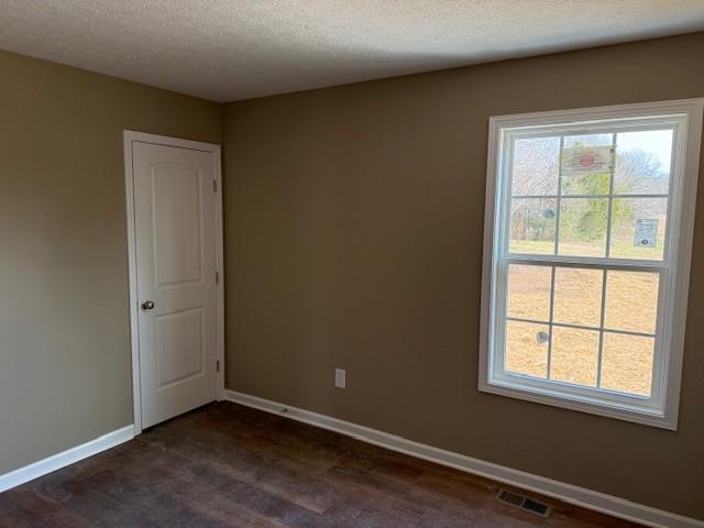 spare room with a textured ceiling