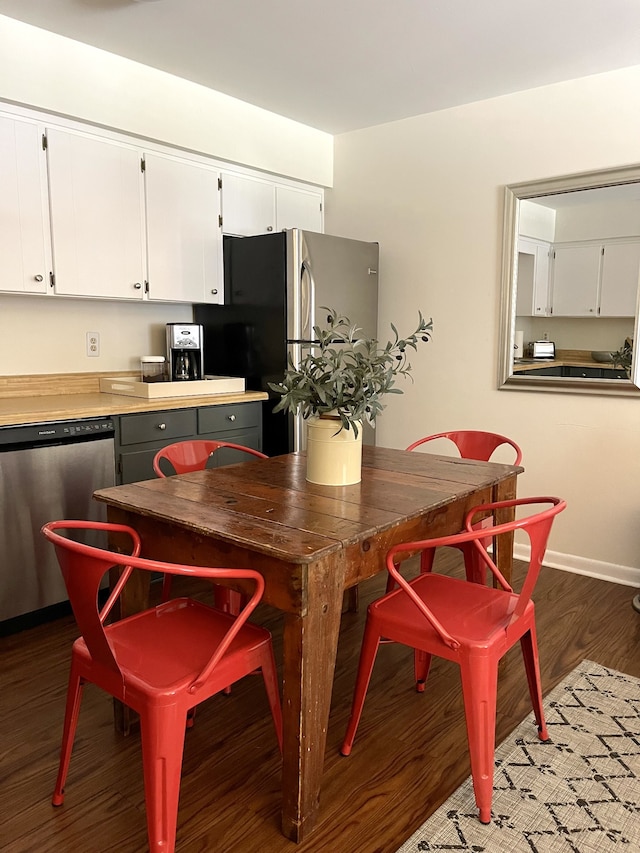 dining space with dark hardwood / wood-style flooring