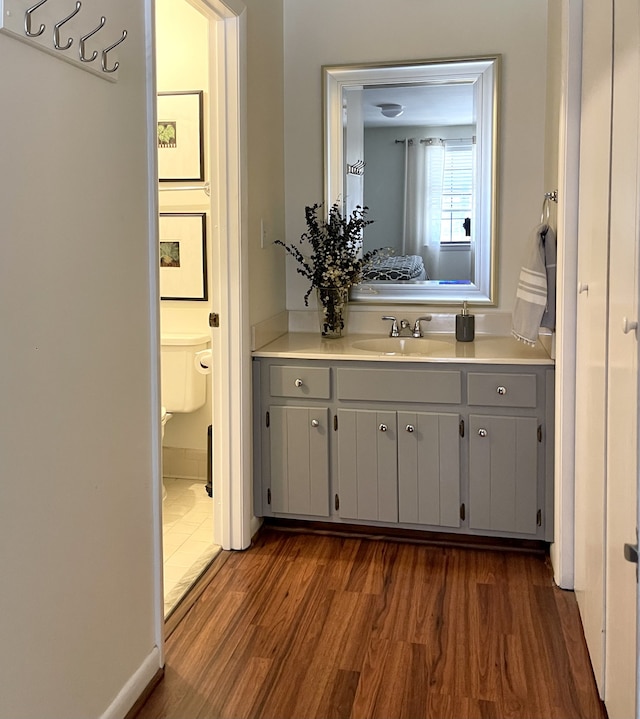 bathroom featuring hardwood / wood-style floors, vanity, and toilet