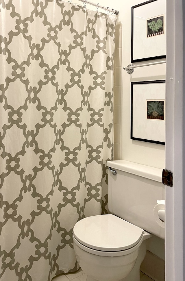 bathroom with toilet and tile patterned floors