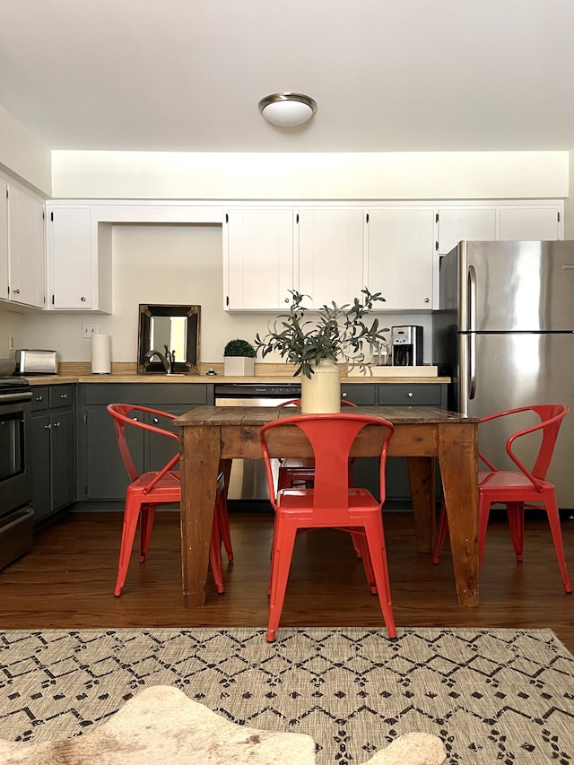 kitchen featuring white cabinets, hardwood / wood-style floors, and stainless steel appliances