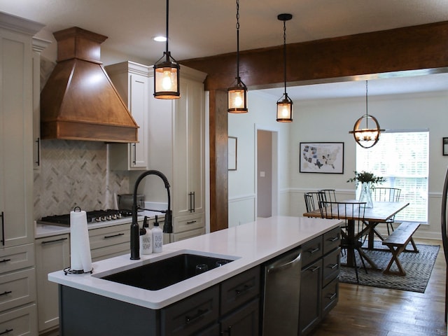 kitchen with hanging light fixtures, a kitchen island, dark hardwood / wood-style flooring, stainless steel appliances, and custom exhaust hood