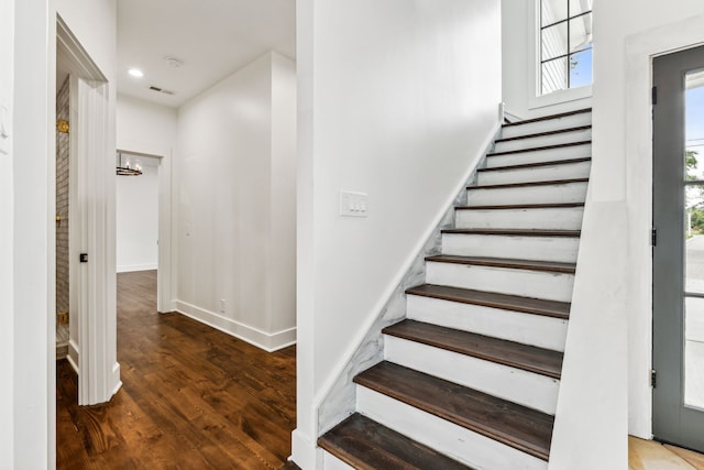 stairs featuring wood-type flooring