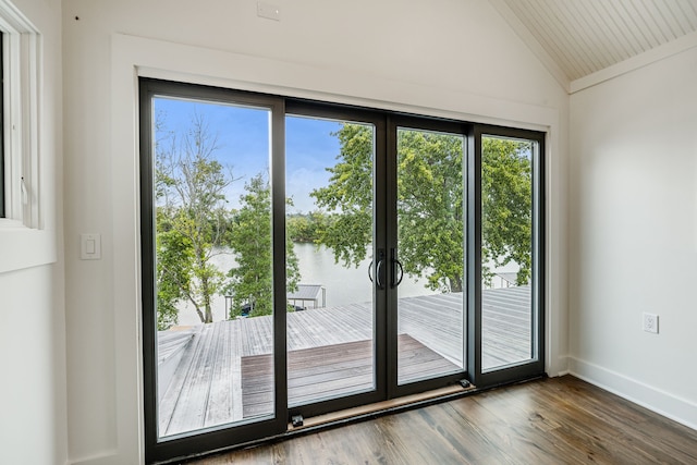 doorway to outside featuring lofted ceiling, a water view, and wood-type flooring