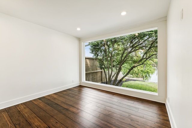 spare room with dark hardwood / wood-style floors