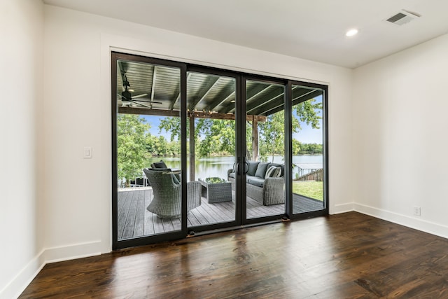 entryway featuring a water view and dark hardwood / wood-style floors