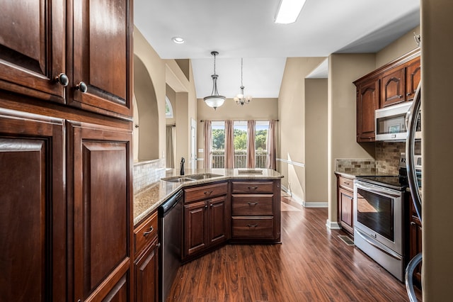 kitchen featuring light stone countertops, sink, dark wood-type flooring, and stainless steel appliances